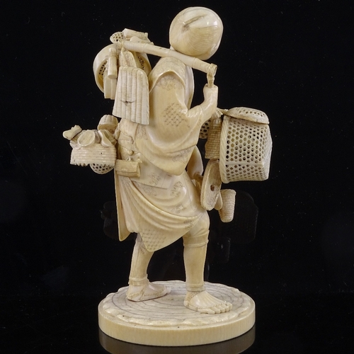 162 - A Japanese ivory okimono of a basket seller, Meiji Period, with inset signed jade plaque under base,... 