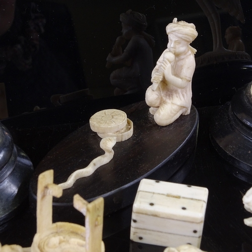 169 - A group of Indian and Chinese ivory carvings, including a snake charmer