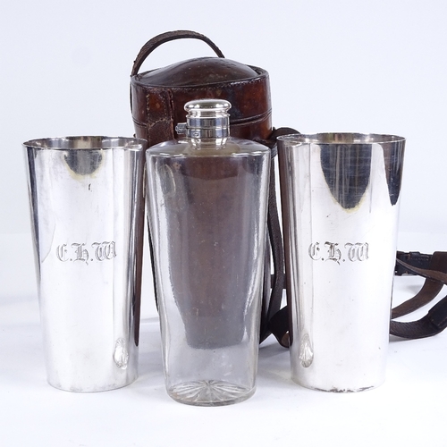 86 - A 19th century leather-cased picnic drinks set, comprising a tapered glass flask and pair of plated ... 