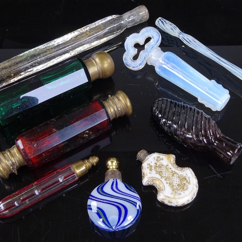 184 - A group of mainly 19th century glass scent bottles, including ruby and green double-ended, and an op... 