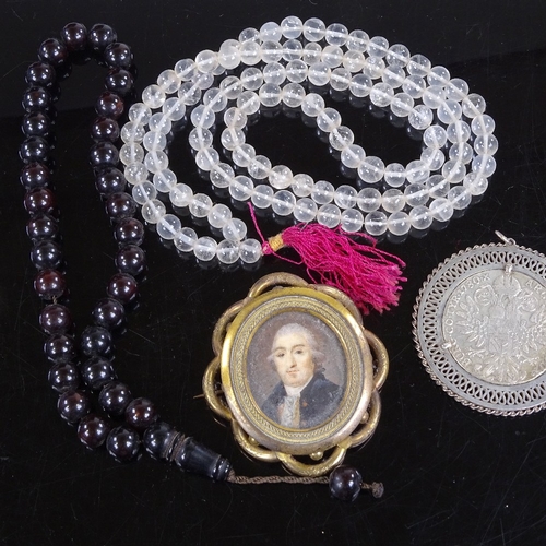 213 - A rock crystal bead necklace, a Victorian gilt-metal brooch with inset painted portrait, a coin set ... 