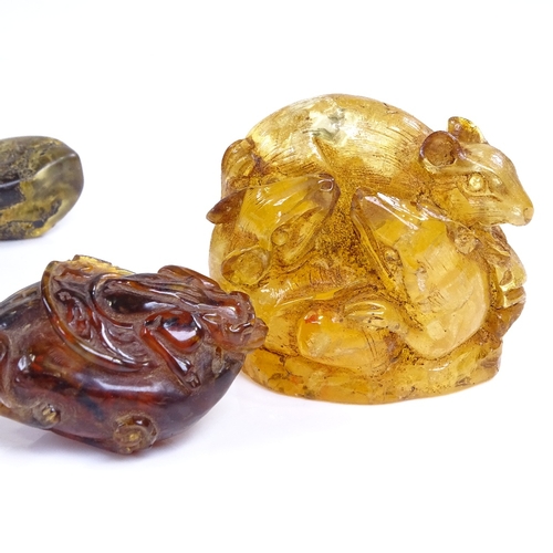 217 - A group of amber, including a relief carved Chinese teapot, length 10cm