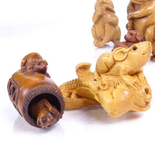 224 - A group of Japanese carved wood netsuke, including a rat holding his tail, height 5cm