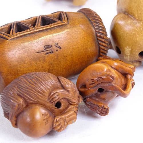 224 - A group of Japanese carved wood netsuke, including a rat holding his tail, height 5cm