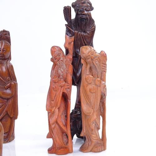 237 - A group of Oriental carved wood standing figures, largest height 17cm