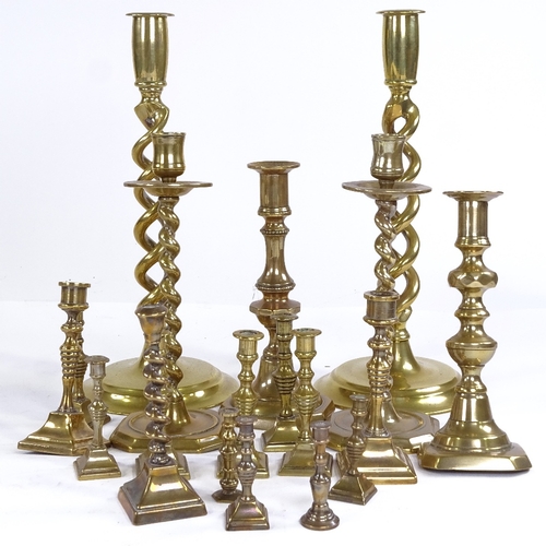 251 - A collection of brass candlesticks, including a pair of open twist, height 30cm