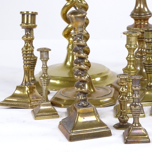 251 - A collection of brass candlesticks, including a pair of open twist, height 30cm