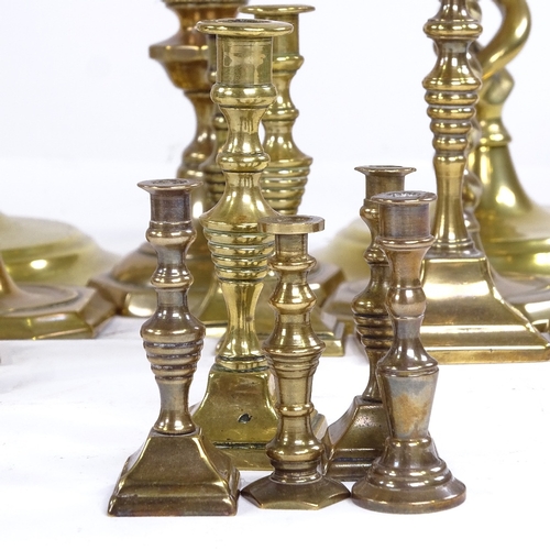 251 - A collection of brass candlesticks, including a pair of open twist, height 30cm