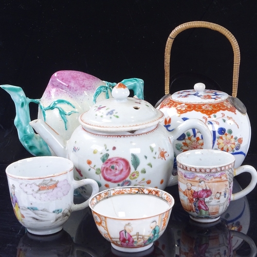 256 - A group of Chinese porcelain teapots and cups, including a fruit design Cadogan teapot, height 12cm