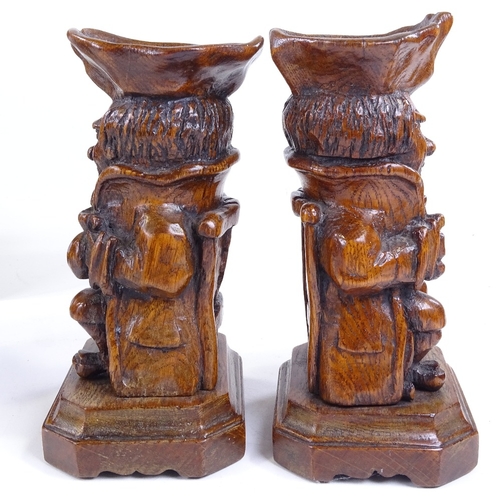 263 - A pair of carved oak Toby figure candle stands, height 22cm, and 2 other wood carvings (4)