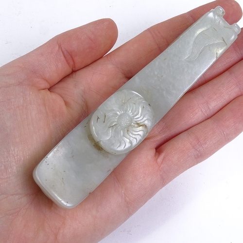 323 - A Chinese relief carved jade dragon design buckle, length 11.5cm