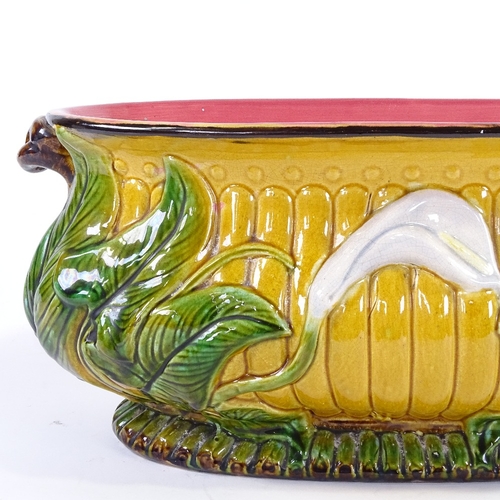 365 - A 19th century Majolica Pottery oval jardiniere, with relief moulded lily flower designs, no factory... 