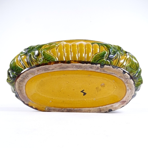 365 - A 19th century Majolica Pottery oval jardiniere, with relief moulded lily flower designs, no factory... 