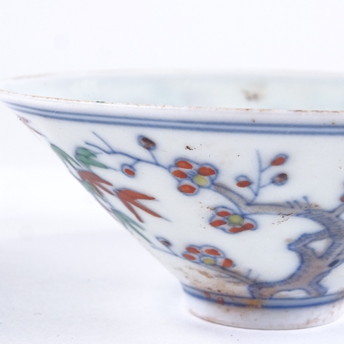 428 - A Chinese porcelain tea bowl with painted blossom tree designs, 6 character mark, diameter 8.5cm