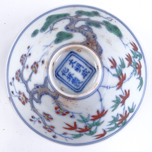 428 - A Chinese porcelain tea bowl with painted blossom tree designs, 6 character mark, diameter 8.5cm