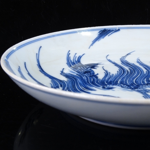 431 - A Chinese blue and white porcelain dish, with painted dragon design, 6 character mark, diameter 17cm