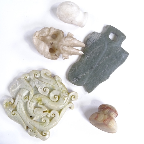 437 - A collection of stone carvings, including Chinese jade, South American carvings, and Maori green sto... 