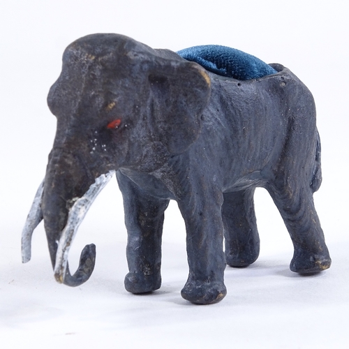 443 - A cold painted bronze elephant design pin cushion, length 7cm