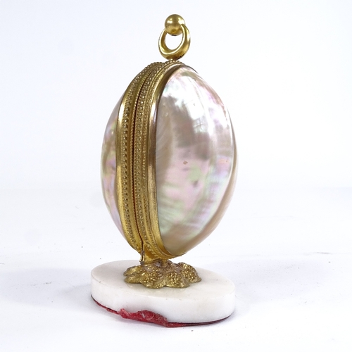 467 - A 19th century mother-of-pearl shell box, containing 4 original cut-glass perfume bottles with gilt-... 