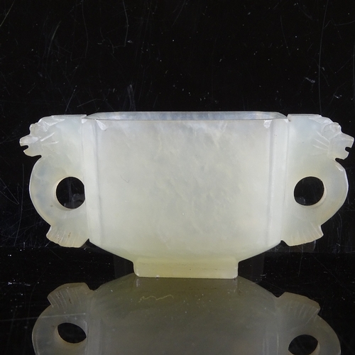 474 - A Chinese pale celadon jade 2-handled Gui cup, dragon decorated handles, 8cm across, 38mm