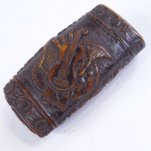 493 - A 19th century coquilla nut snuffbox, all over relief carved musical instruments in floral border, l... 