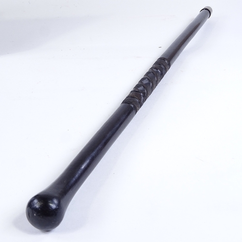 507 - An ebony baton stick with spiral carved design, possibly military, length 61cm