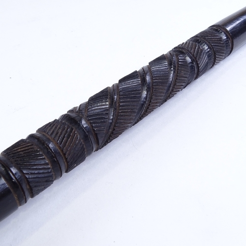 507 - An ebony baton stick with spiral carved design, possibly military, length 61cm