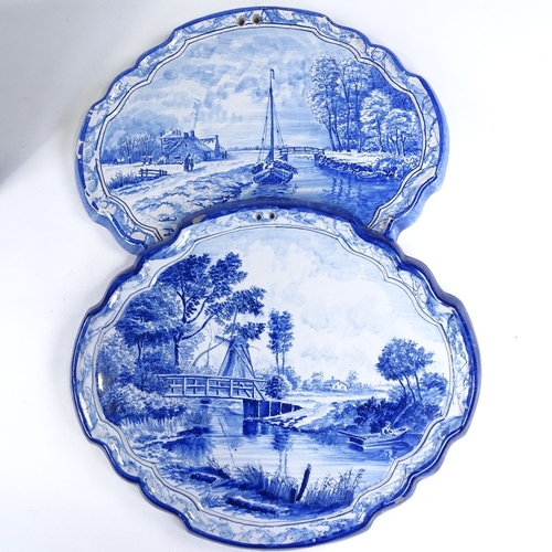 510 - A pair of Delft blue and white pottery wall plaques, with painted river scenes, width 38cm, height 3... 