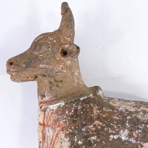 514 - An Antiquity terracotta bull with traces of original paintwork, missing front legs, height approx 50... 