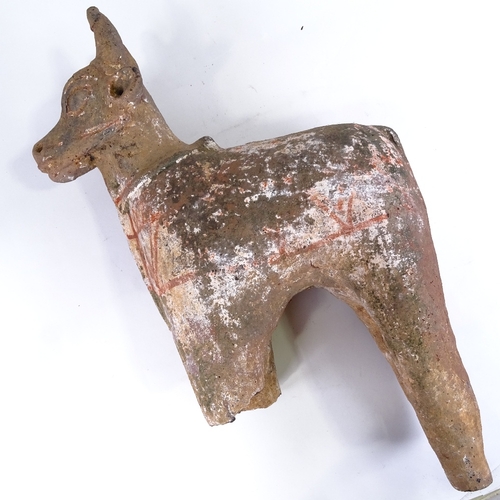 514 - An Antiquity terracotta bull with traces of original paintwork, missing front legs, height approx 50... 