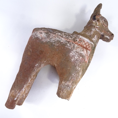 514 - An Antiquity terracotta bull with traces of original paintwork, missing front legs, height approx 50... 