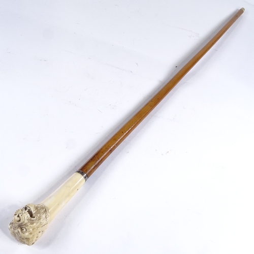 519 - A 19th century walking cane with carved ivory leopard's head handle