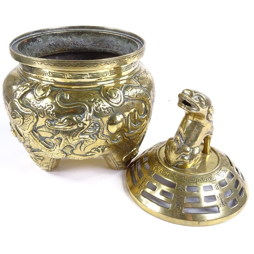 520 - A Chinese polished bronze incense burner and cover, with dragon knop and relief moulded dragon surro... 