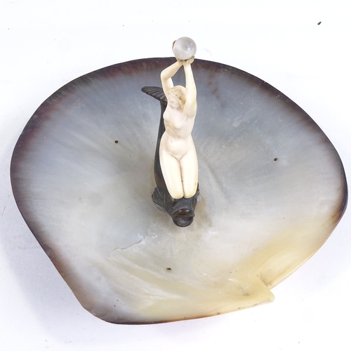 524 - An Art Deco abalone shell dish, surmounted by a carved ivory nude woman on a bronze gurgle fish, dis... 