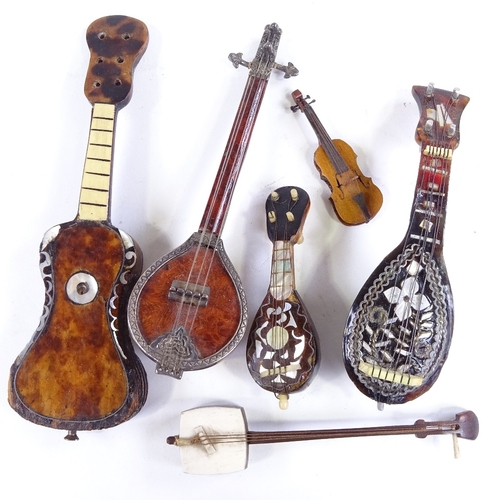 534 - A small group of miniature mother-of-pearl mandolins, guitars and other instruments (6)