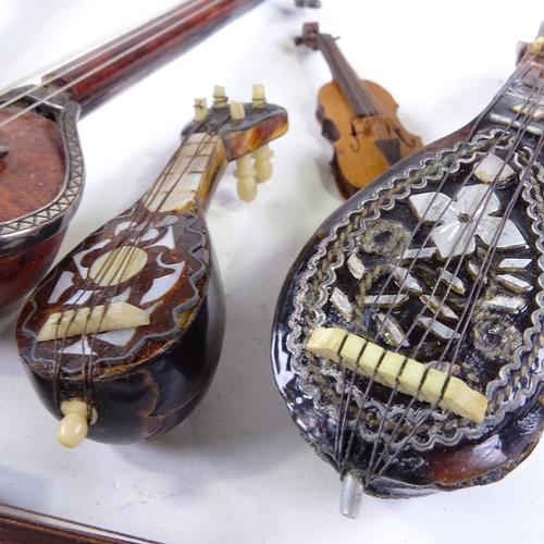 534 - A small group of miniature mother-of-pearl mandolins, guitars and other instruments (6)