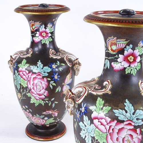 559 - A pair of 19th century porcelain vases and covers, with enamel decoration and gilded ram's head hand... 