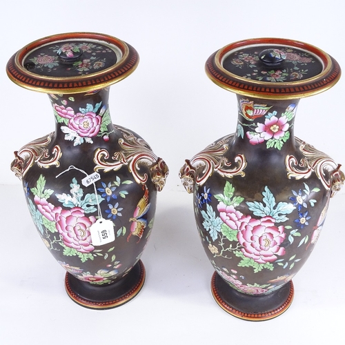 559 - A pair of 19th century porcelain vases and covers, with enamel decoration and gilded ram's head hand... 