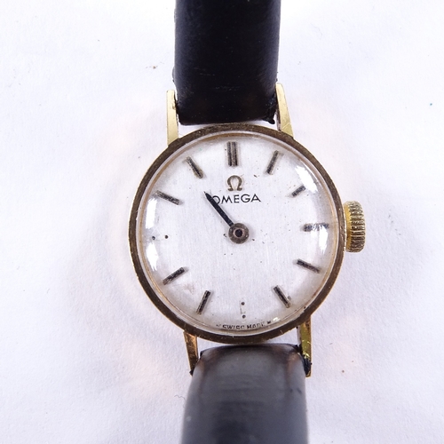 1026 - OMEGA - a lady's Vintage 9ct gold mechanical wristwatch, silvered dial with gilt baton hour markers,... 