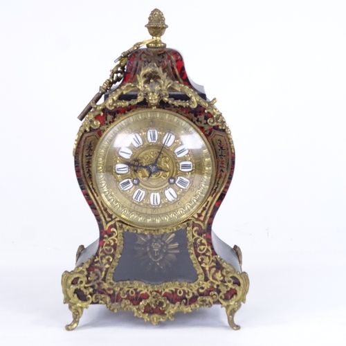 1060 - A 19th century French tortoiseshell and brass boulle work 8-day mantel clock, shaped case with glass... 