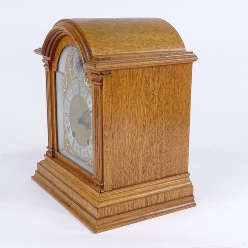 1062 - A late 19th/early 20th century German light oak-cased dome-top mantel clock, by Lenzkirch, architect... 