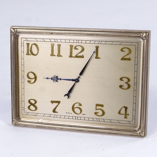 1064 - An Art Deco Swiss 8-day desk clock, brass frame with brushed brass dial and applied gilt Arabic nume... 