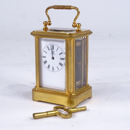 1065 - A 19th century miniature brass-cased carriage clock timepiece, white enamel dial with Roman numeral ... 