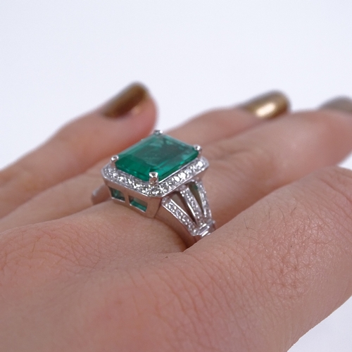 1107 - A rectangular emerald and diamond cluster ring, central large emerald step-cut emerald approx 3.88ct... 