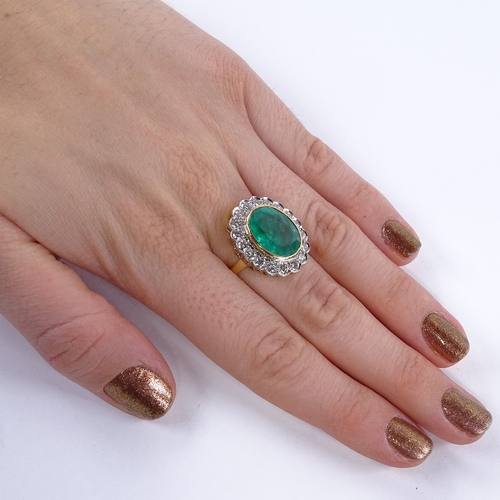 1108 - A large oval emerald and diamond cluster ring, central oval mixed-cut emerald approx 6.75ct, surroun... 