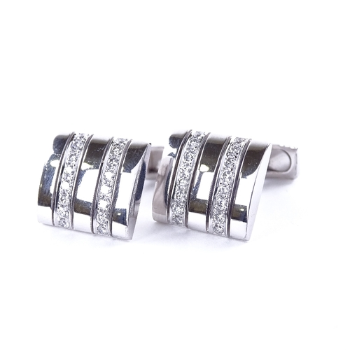 1117 - A pair of 18ct white gold diamond cufflinks, each rectangular panel set with a double-row of round b... 