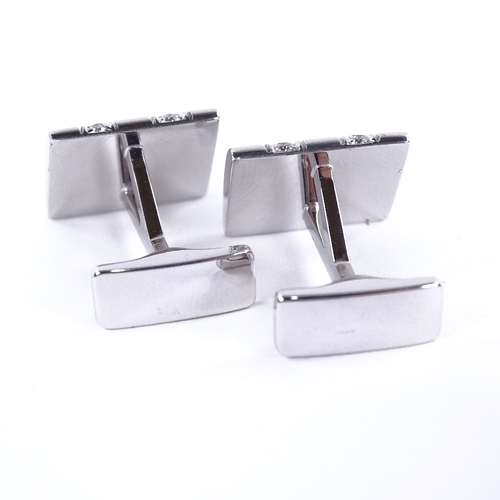 1117 - A pair of 18ct white gold diamond cufflinks, each rectangular panel set with a double-row of round b... 