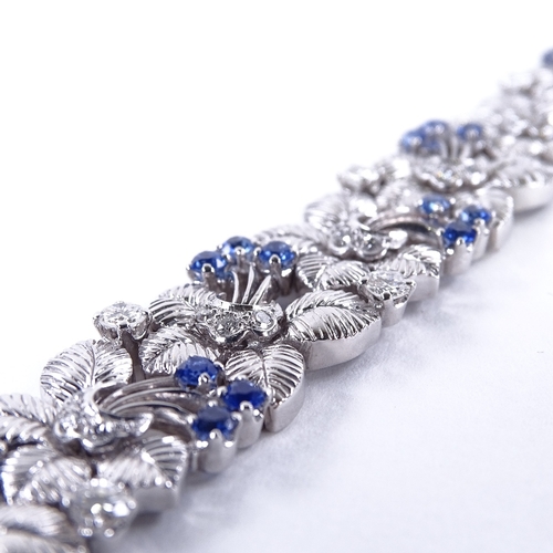 1118 - A sapphire and diamond floral bracelet, floral spray panels set with round-cut sapphires and diamond... 