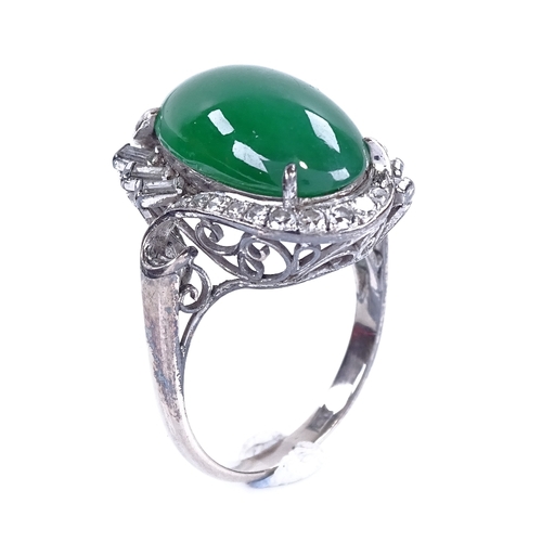 1120 - A cabochon jadeite and diamond cluster ring, set with large central cabochon jadeite, surrounded by ... 