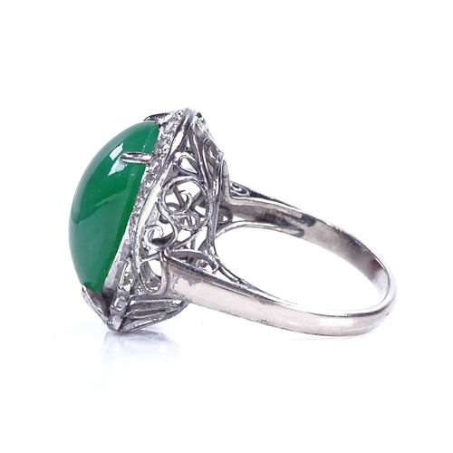 1120 - A cabochon jadeite and diamond cluster ring, set with large central cabochon jadeite, surrounded by ... 